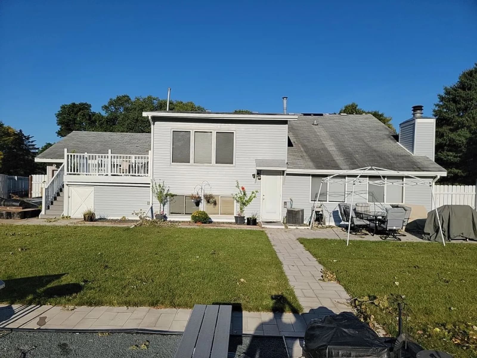 Apple Valley split-level home before roof replacement, showing the aging streaked asphalt roof