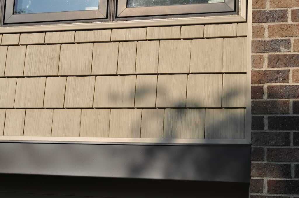 LP SmartSide engineered wood shingle siding on a Twin Cities home — the kind of color-matched repair Modex delivers