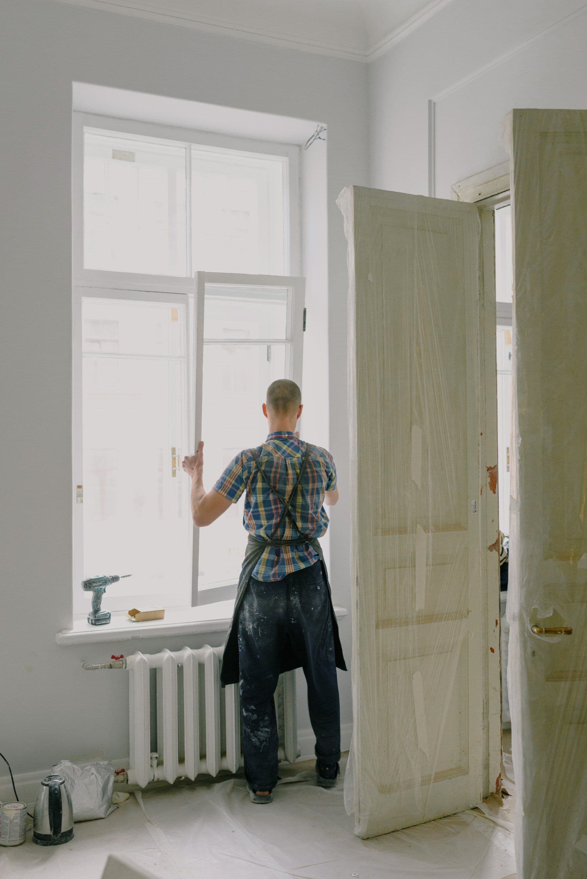 Modex installer working on a Twin Cities window — repair-scope work in progress