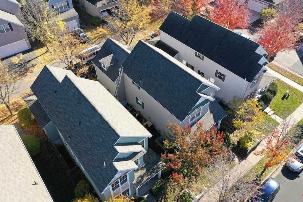 Aerial view of Shakopee homes with mature fall tree cover