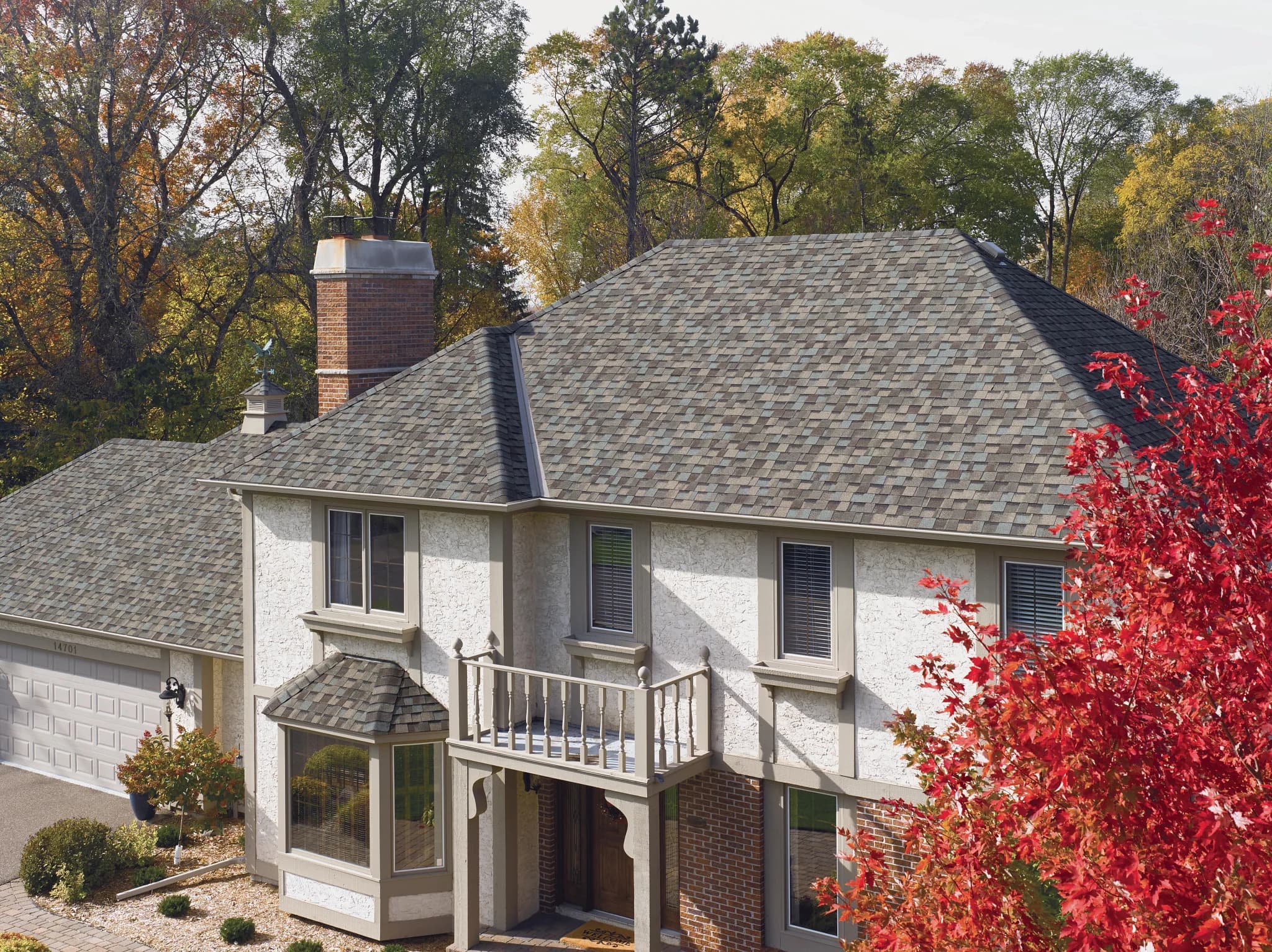 CertainTeed NorthGate ClimateFlex in Weathered Wood on a stucco home