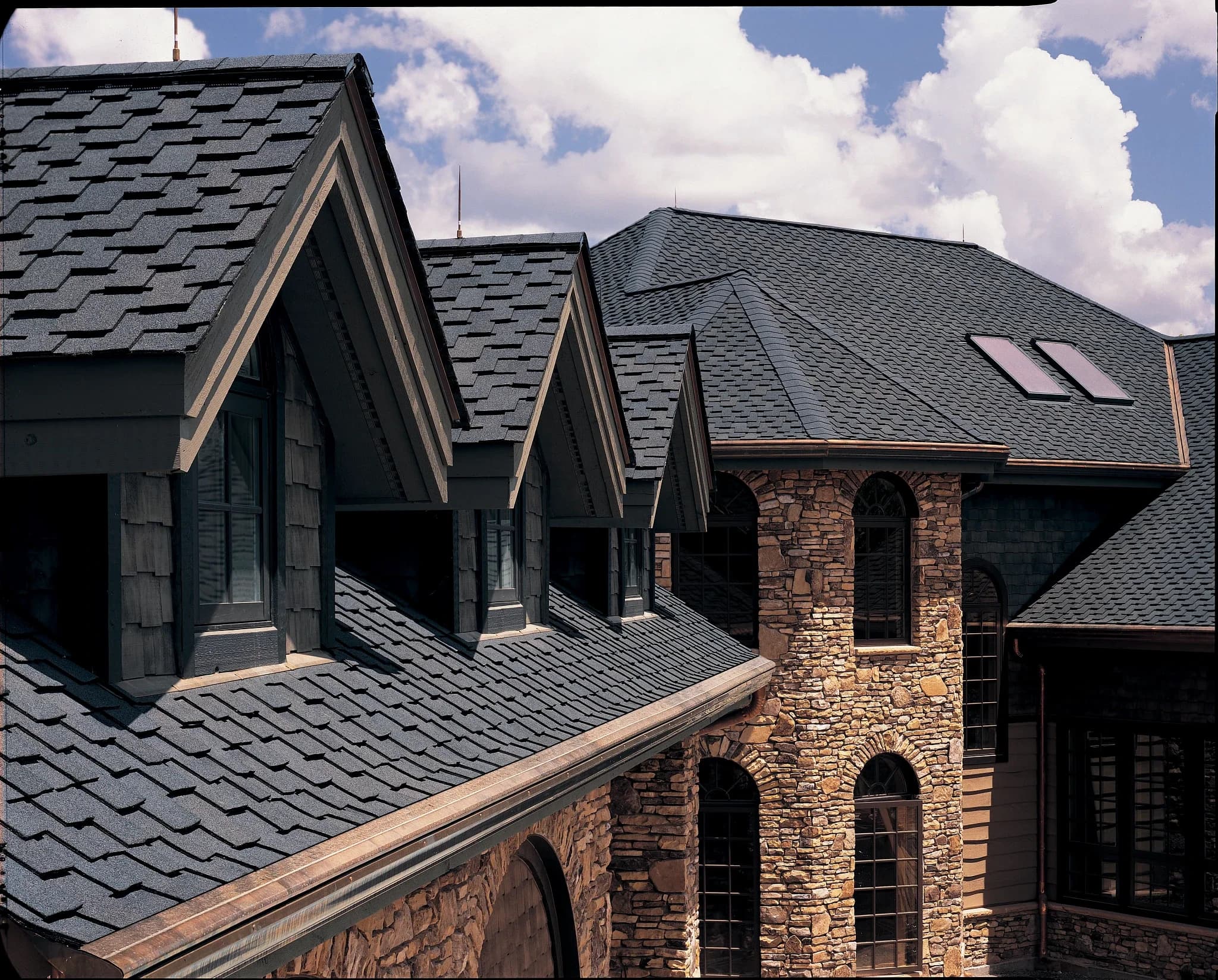 CertainTeed Presidential Shake TL in Shadow Gray on a stone-clad luxury home