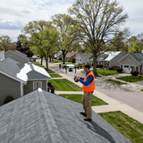 Modex inspector documenting roof damage for an insurance claim packet