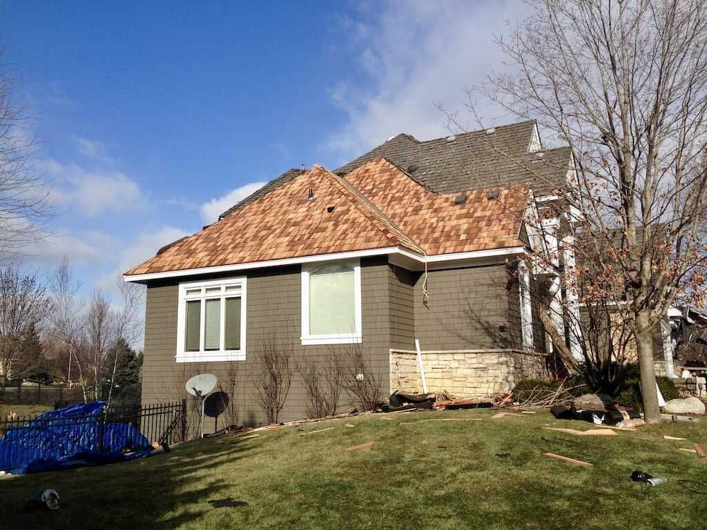 Side view of a Twin Cities home featuring a new cedar shake roof