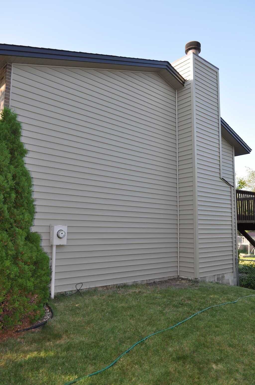 Two-story home featuring beige LP SmartSide siding installation