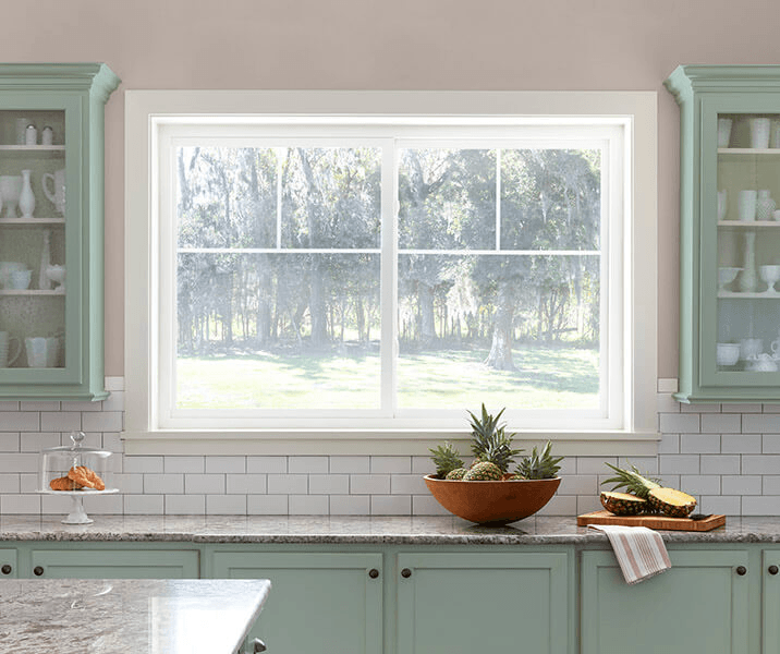 Pella Defender Series sliding window in a green kitchen